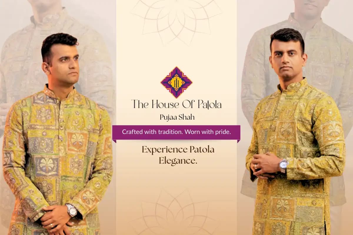 Close up of Patola silk fabric showing natural dye colours in traditional double ikat patterns with rich red, mustard, and green tones.